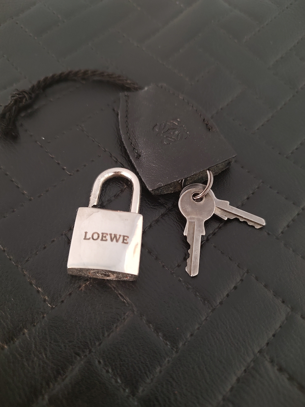 Loewe silvertone lock and two keys w/leather tag EUC